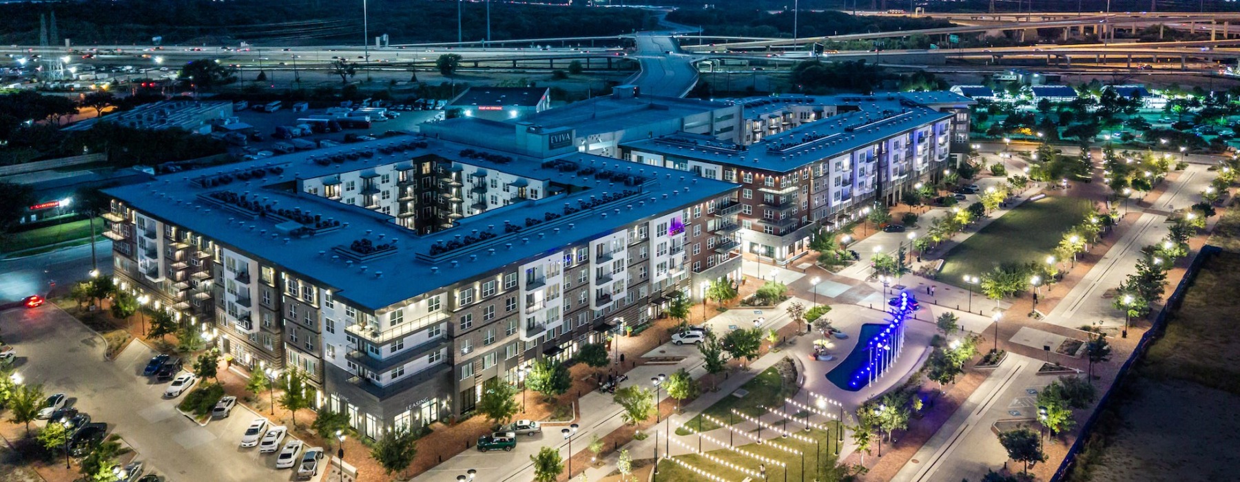 EVIVA Trinity Mills Station night aerial view, Apartments in downtown Carrollton, TX