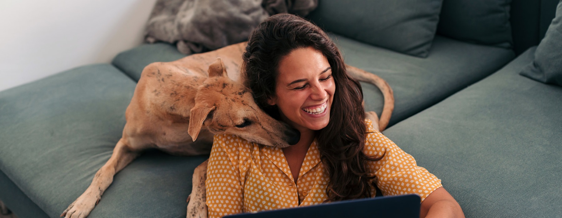 a woman and her dog on a sofa