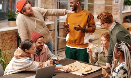 Group of friends gathered around a table spending time together.