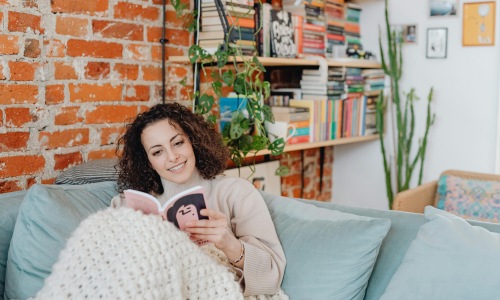 Woman at EVIVA apartment reading a book
