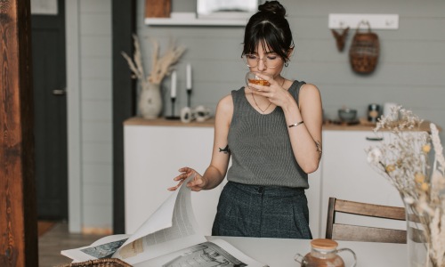 Woman enjoying a warm cup of tea at home.